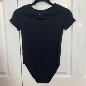 Black bodysuit with crossover design on front, Justice brand, black leotard.